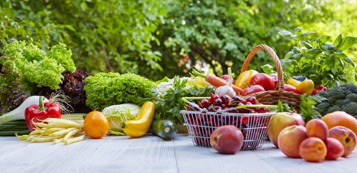 Image of fruit and vegetables on a picnic table.