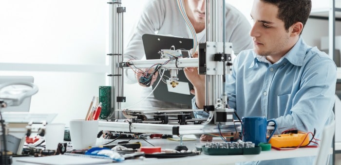 Workers preparing 3D-printing assembly