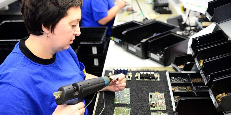 FuzeHub and NYAII Partnership, Woman assembles electronic parts