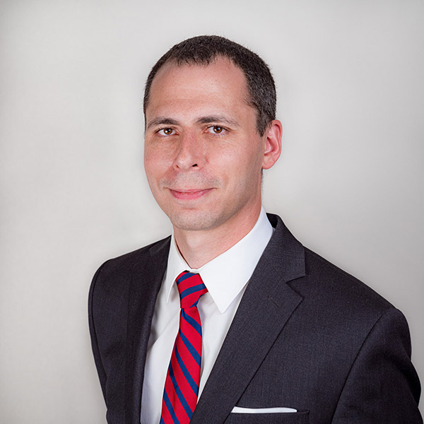 FuzeHub's Ben Weinberg dressed in a suit with red & blue striped tie