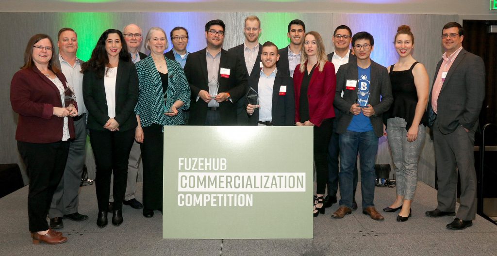 Participants of the FuzeHub Commercialization Competition on stage with members of the FuzeHub team