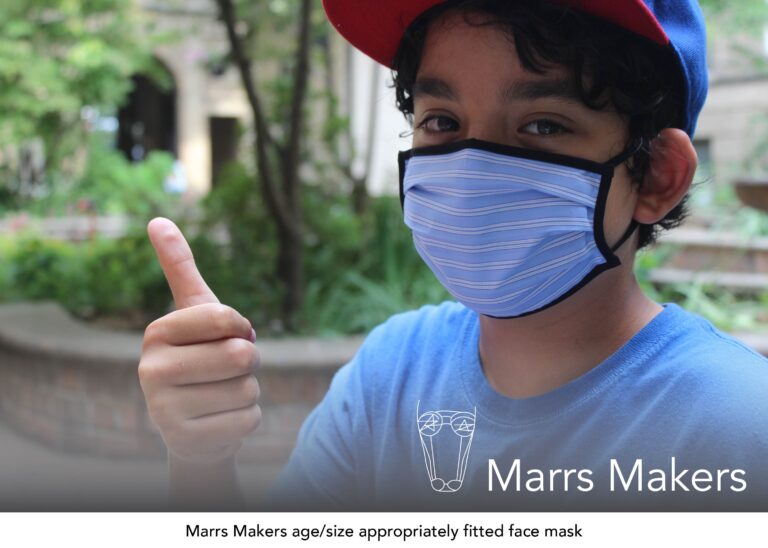 Young boy in a blue basebal cap wearing a custom fit blue-striped Marrs Makers face mask giving a thumbs up.