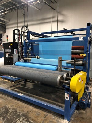 Blue material on large rollers