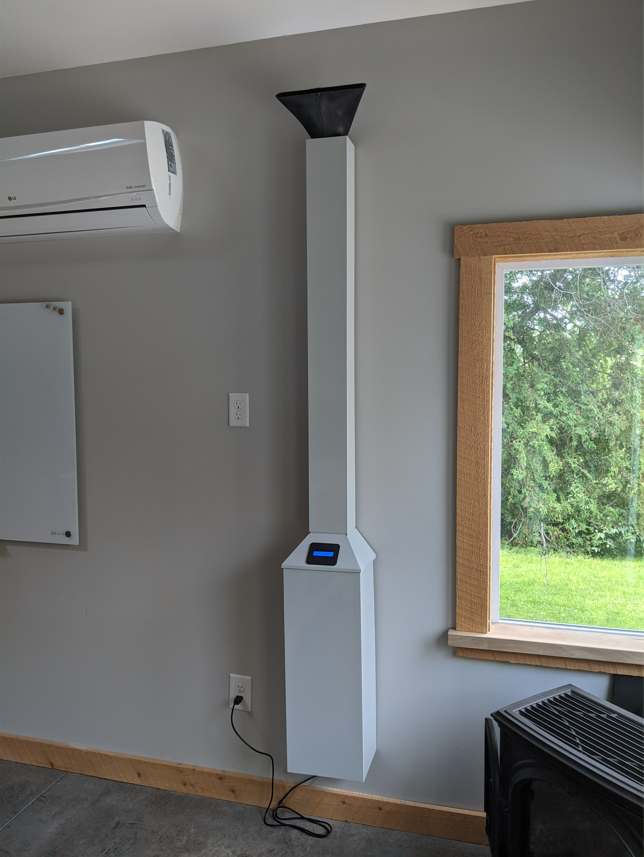 A wall mounted air cleaner near a window