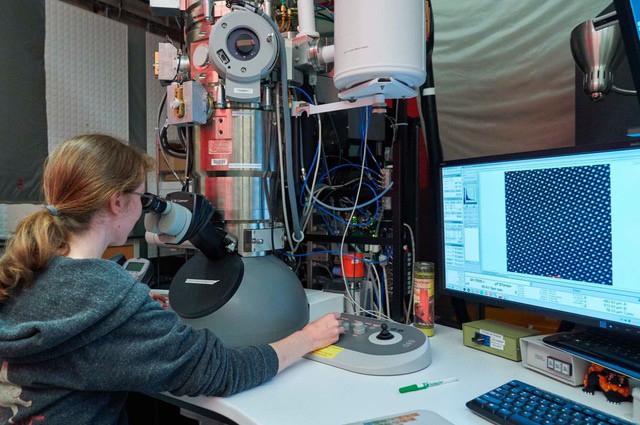 student using microscope